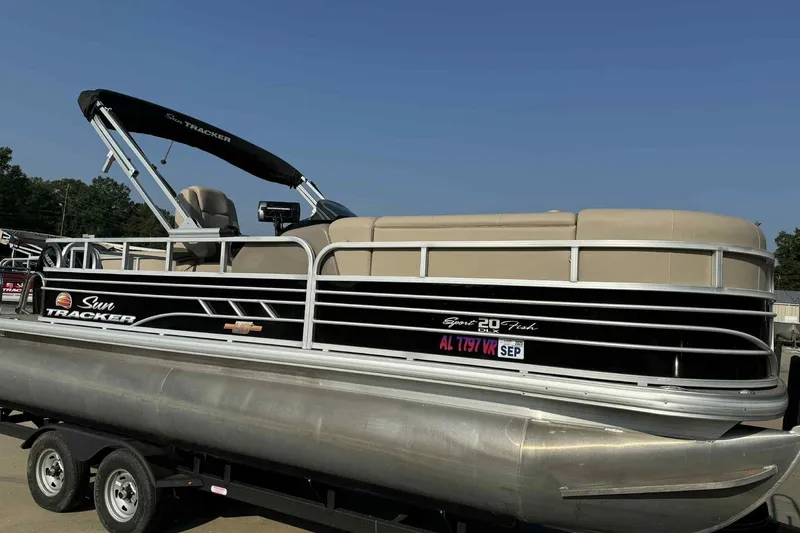 The Image of 2023 Sun Tracker SportFish 20 DLX pontoon boat on trailer, side view. - 0