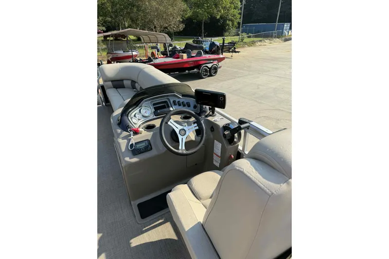 Slide: The Image of 2023 Sun Tracker SportFish 20 DLX boat interior with steering console and seating. - 8