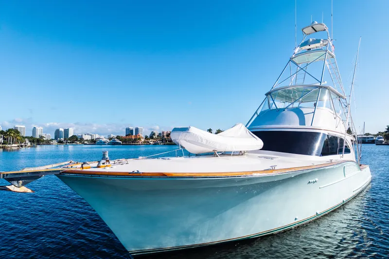 The Image of Luxury 2004 B&D 65 Flybridge yacht on calm water under clear blue sky. - 0