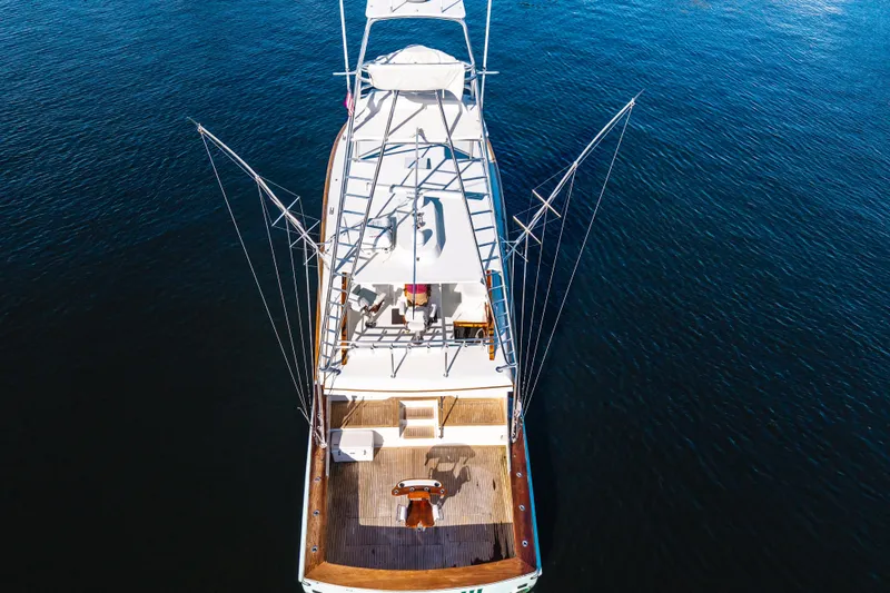 Slide: The Image of Aerial view of 2004 B&D 65 Flybridge yacht on calm blue water. - 3