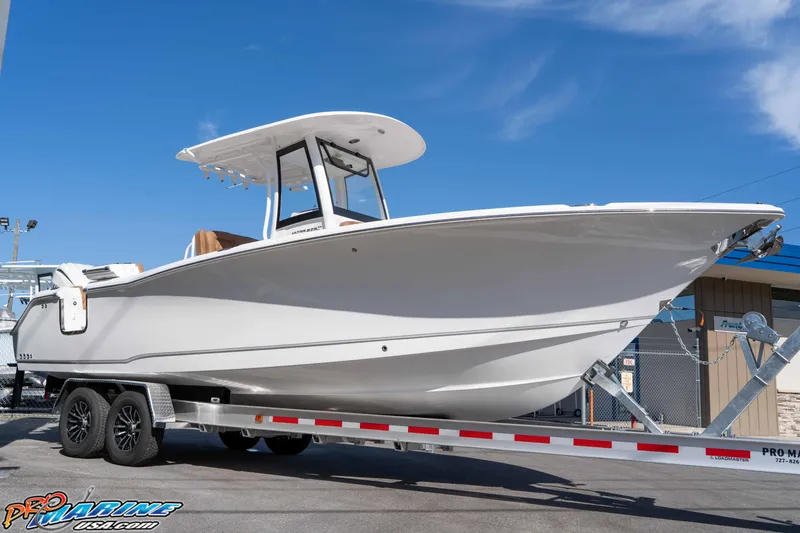 Slide: The Image of 2026 Sea Hunt Ultra 275 SE boat on trailer under clear blue sky. - 14