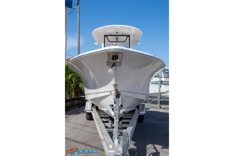 Slide: The Image of 2026 Sea Hunt Ultra 275 SE boat on trailer, viewed from front, under clear blue sky. - 15