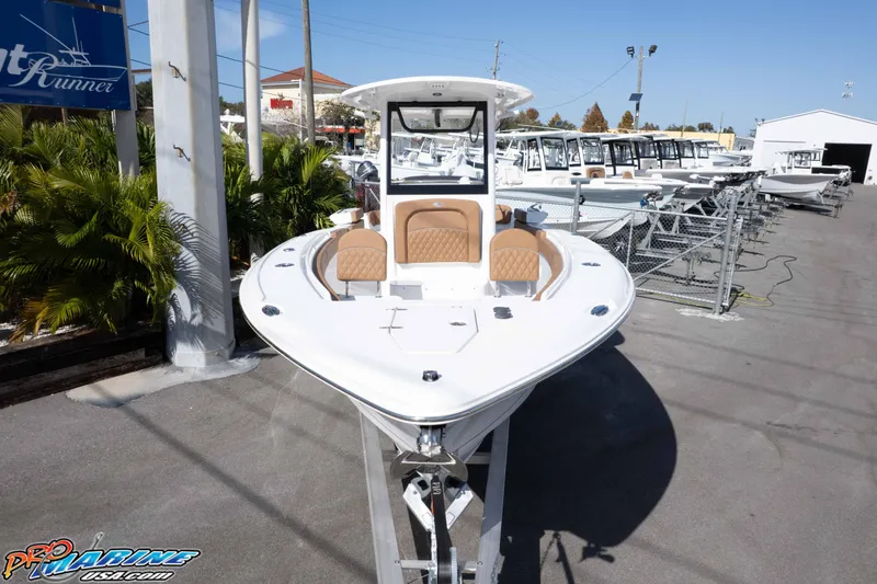 Slide: The Image of 2026 Sea Hunt Ultra 275 SE boat displayed at a dealership under clear blue skies. - 16