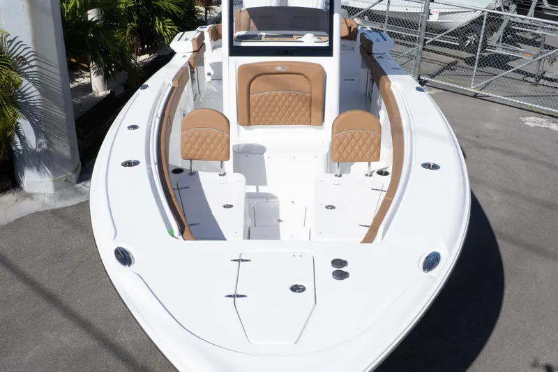 Slide: The Image of 2026 Sea Hunt Ultra 275 SE boat with tan seating and sleek white design. - 17
