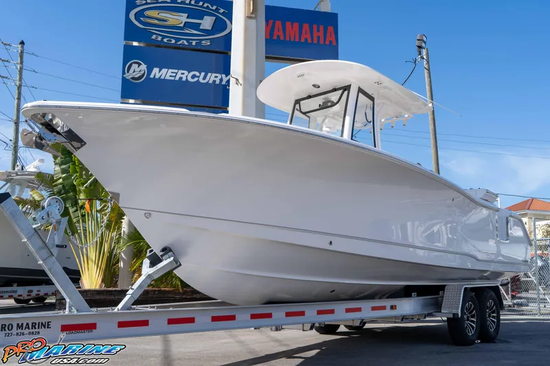 Slide: The Image of 2026 Sea Hunt Ultra 275 SE boat on trailer at dealership, clear sky background. - 2