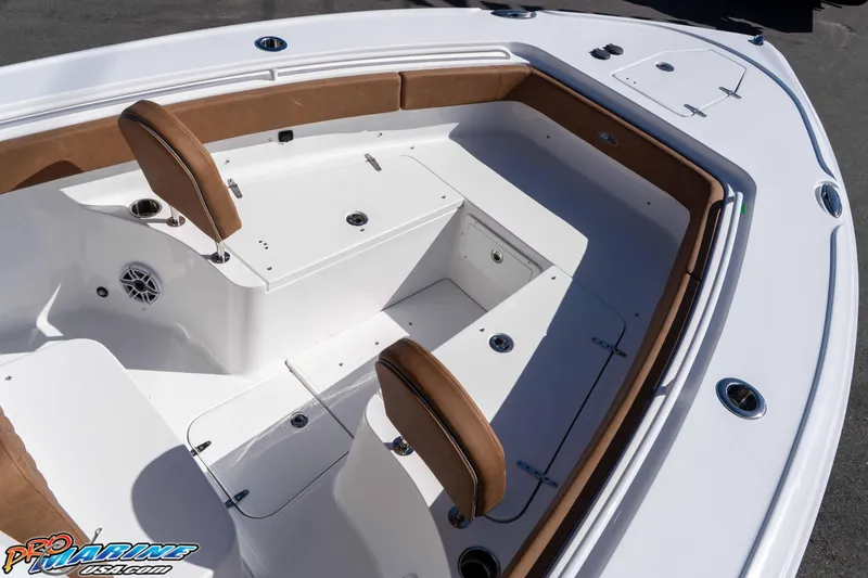 Slide: The Image of 2026 Sea Hunt Ultra 275 SE boat interior with brown seating and storage compartments. - 21