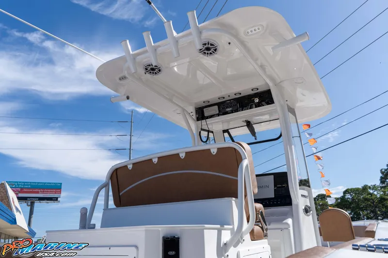 Slide: The Image of 2026 Sea Hunt Ultra 275 SE boat with T-top and electronics, displayed outdoors. - 26