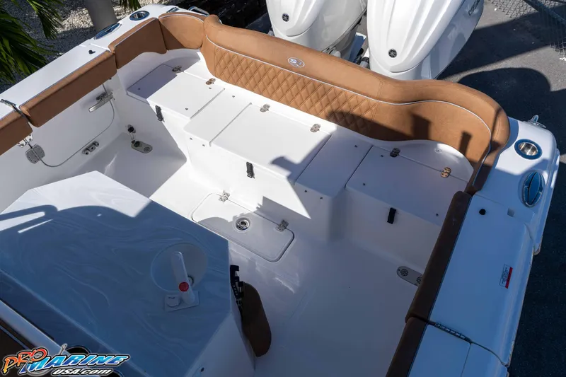 Slide: The Image of 2026 Sea Hunt Ultra 275 SE boat interior with tan seating and storage compartments. - 27