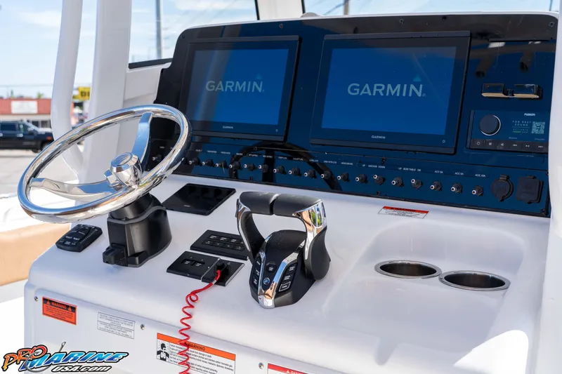 Slide: The Image of Control panel of 2026 Sea Hunt Ultra 275 SE with Garmin displays and steering wheel. - 33
