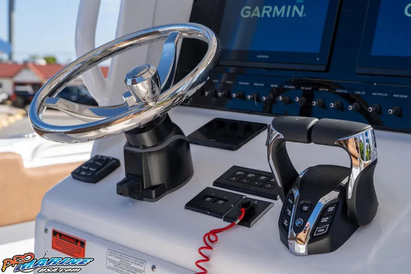 Slide: The Image of Steering console of 2026 Sea Hunt Ultra 275 SE with Garmin displays and controls. - 34