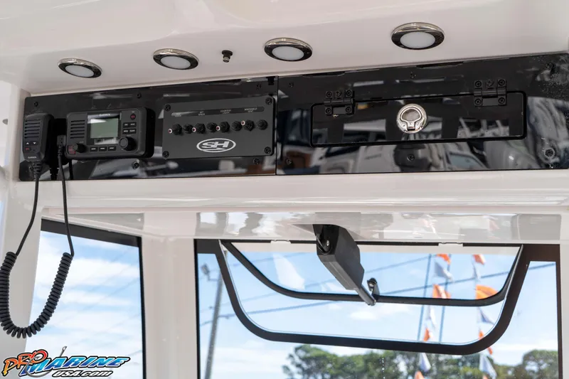 Slide: The Image of 2026 Sea Hunt Ultra 275 SE boat dashboard with electronic controls and communication devices. - 35
