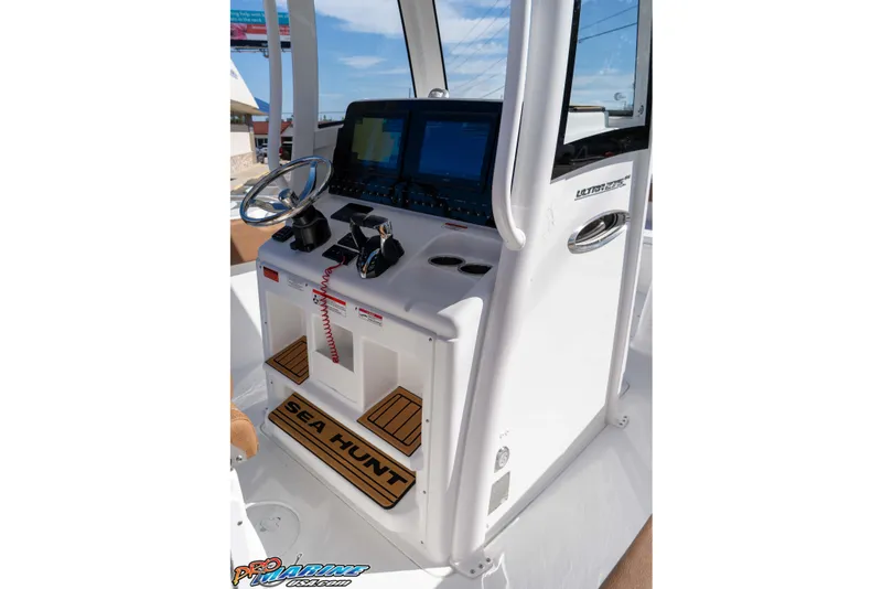 Slide: The Image of 2026 Sea Hunt Ultra 275 SE boat console with steering wheel and navigation screens. - 36