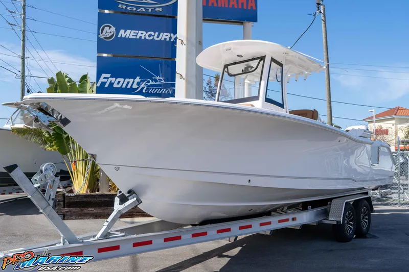 Slide: The Image of 2026 Sea Hunt Ultra 275 SE boat on trailer at dealership, sunny day. - 4