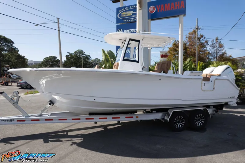 Slide: The Image of 2026 Sea Hunt Ultra 275 SE boat on trailer at dealership, featuring Yamaha signage. - 7