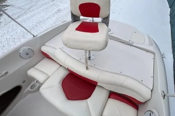 Slide: The Image of 2008 Tahoe Q5i SF boat interior with red and white seating on snowy background. - 22