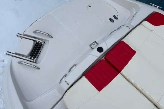 Slide: The Image of 2008 Tahoe Q5i SF boat interior with red and white seating and swim platform. - 28