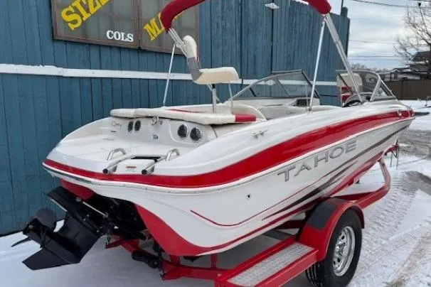 Slide: The Image of 2008 Tahoe Q5i SF boat with red and white design on a trailer. - 4