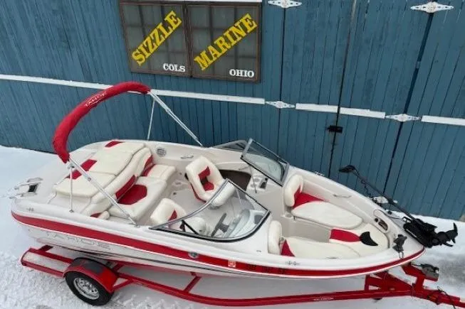 Slide: The Image of 2008 Tahoe Q5i SF boat with red accents on a trailer, parked in snowy area. - 6