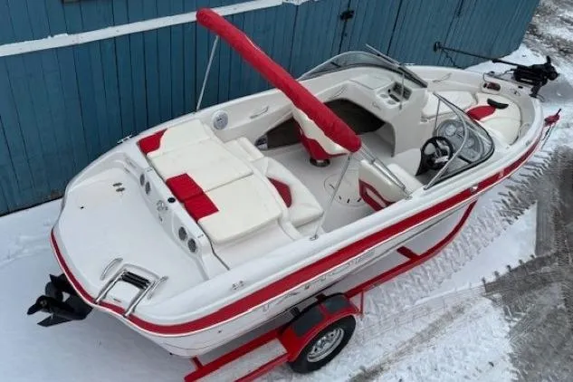 Slide: The Image of 2008 Tahoe Q5i SF boat with red and white interior, parked on snow. - 7