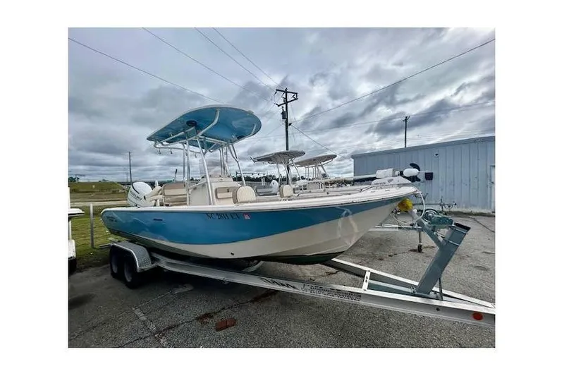 Slide: The Image of 2021 Carolina Skiff 24 Ultra Elite boat on trailer, parked outdoors. - 12