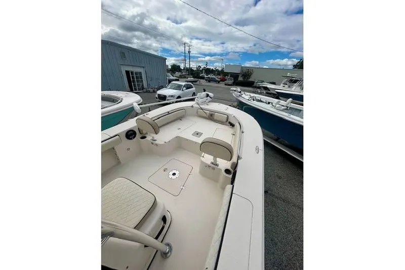 Slide: The Image of 2021 Carolina Skiff 24 Ultra Elite boat with spacious seating, parked outdoors. - 3