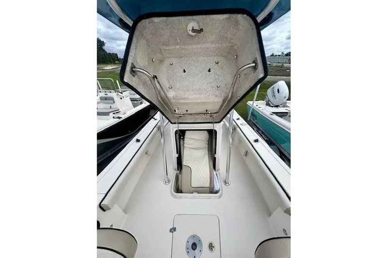 Slide: The Image of 2021 Carolina Skiff 24 Ultra Elite boat interior with open storage compartment. - 5