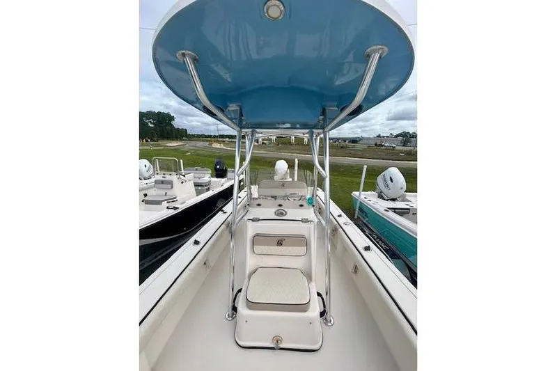 Slide: The Image of 2021 Carolina Skiff 24 Ultra Elite boat interior with blue canopy and seating. - 6