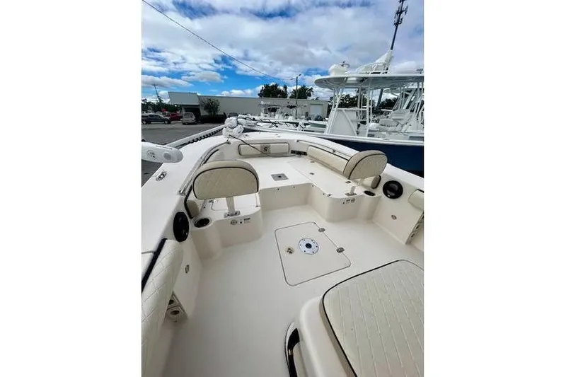 Slide: The Image of 2021 Carolina Skiff 24 Ultra Elite boat interior with seating and storage compartments. - 8