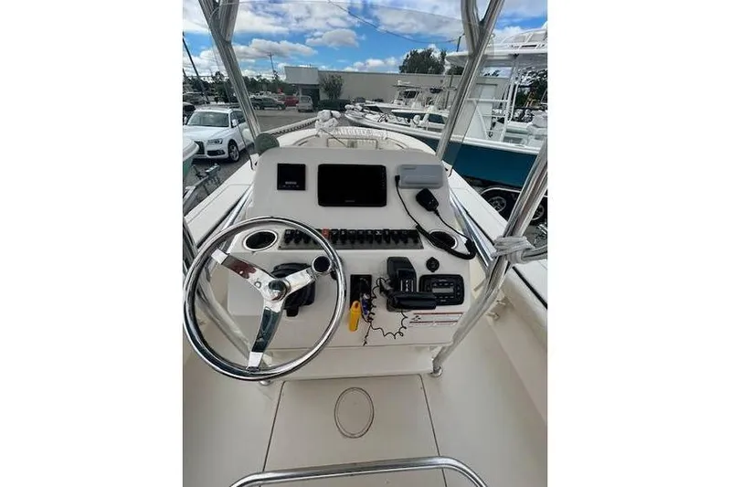 Slide: The Image of 2021 Carolina Skiff 24 Ultra Elite boat console with steering wheel and navigation equipment. - 9