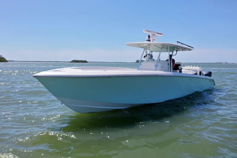 The Image of 2009 Venture 39 Center Console boat on calm waters under clear blue sky. - 0