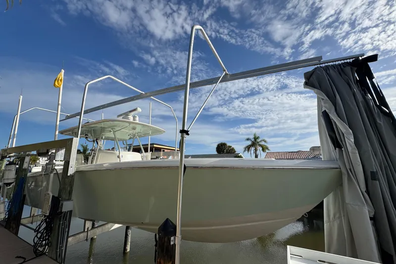 The Image of 2009 Venture 39 Center Console boat docked under a clear blue sky. - 1