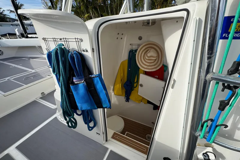 Slide: The Image of 2009 Venture 39 Center Console storage with ropes, life jackets, and a sun hat. - 10