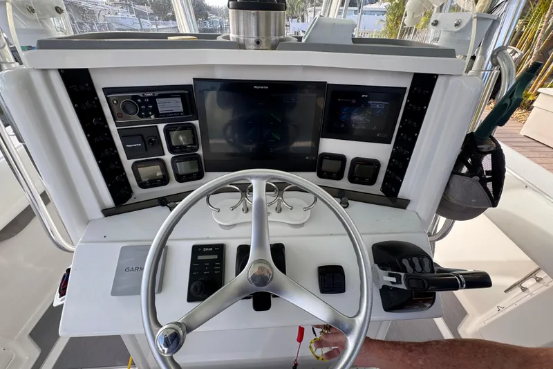 Slide: The Image of 2009 Venture 39 Center Console helm with steering wheel and navigation controls. - 11