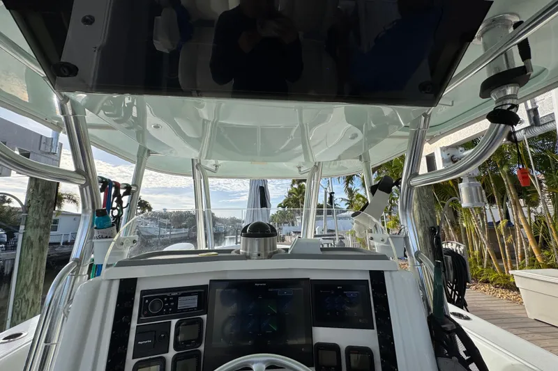 Slide: The Image of 2009 Venture 39 Center Console boat cockpit with advanced navigation system and controls. - 12