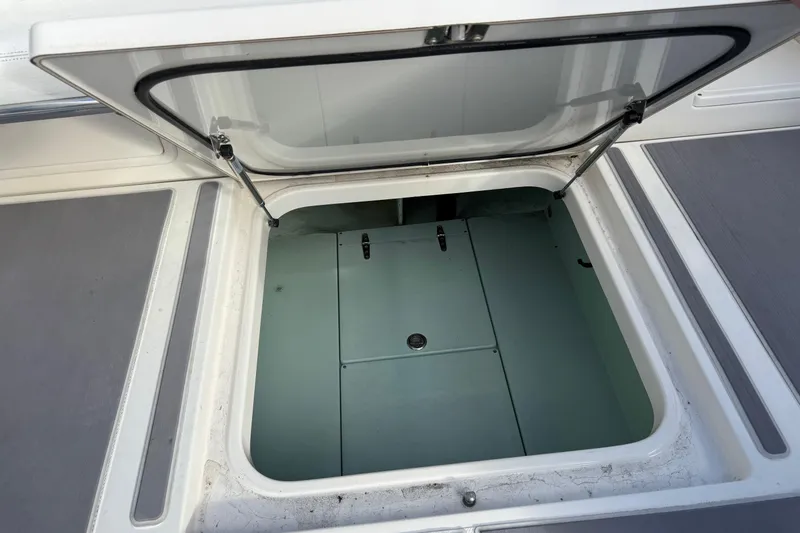 Slide: The Image of Open storage compartment on a 2009 Venture 39 Center Console boat. - 17