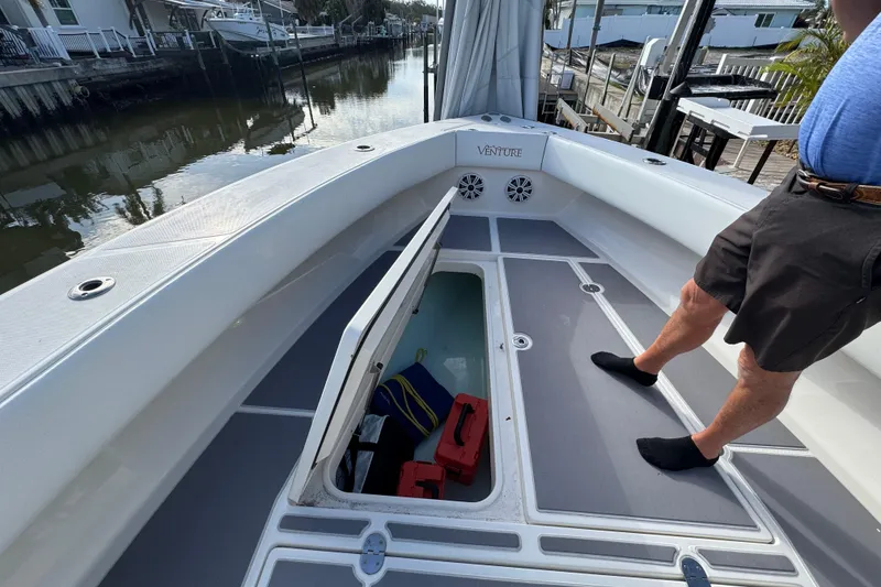 Slide: The Image of 2009 Venture 39 Center Console boat with open storage compartment on deck. - 22