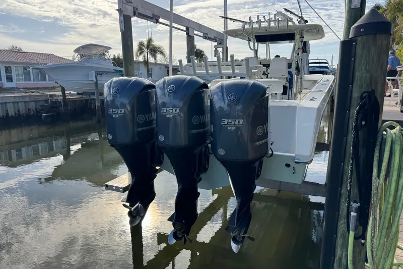 Slide: The Image of 2009 Venture 39 Center Console with triple Yamaha 350 V8 engines docked by waterfront. - 23