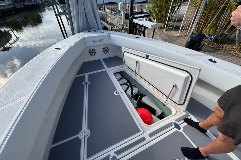 Slide: The Image of 2009 Venture 39 Center Console boat with open storage compartment on deck. - 29