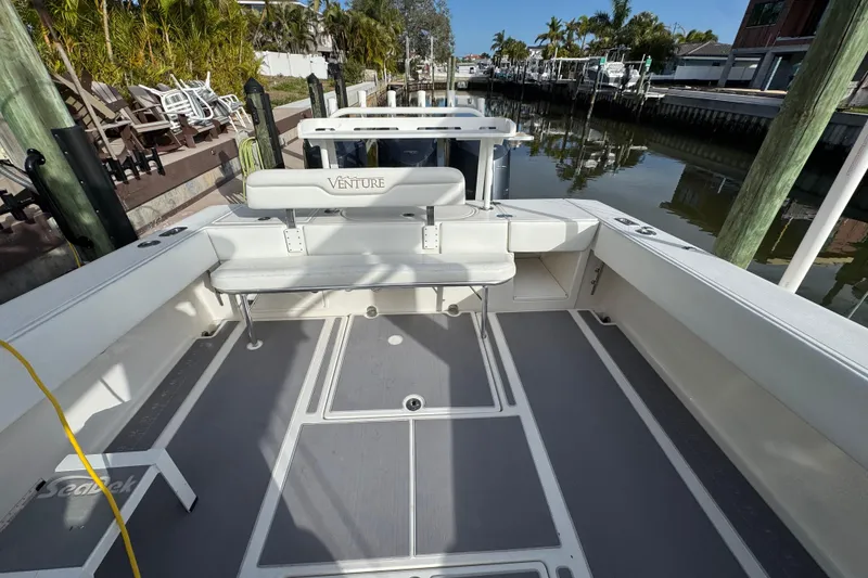 Slide: The Image of 2009 Venture 39 Center Console boat docked, featuring spacious seating and sleek design. - 3