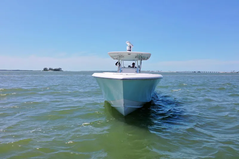 Slide: The Image of 2009 Venture 39 Center Console boat cruising on open water under clear blue sky. - 32
