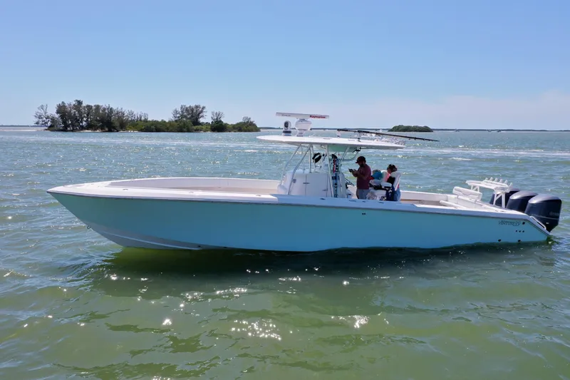 Slide: The Image of 2009 Venture 39 Center Console boat cruising on a sunny day in open waters. - 34