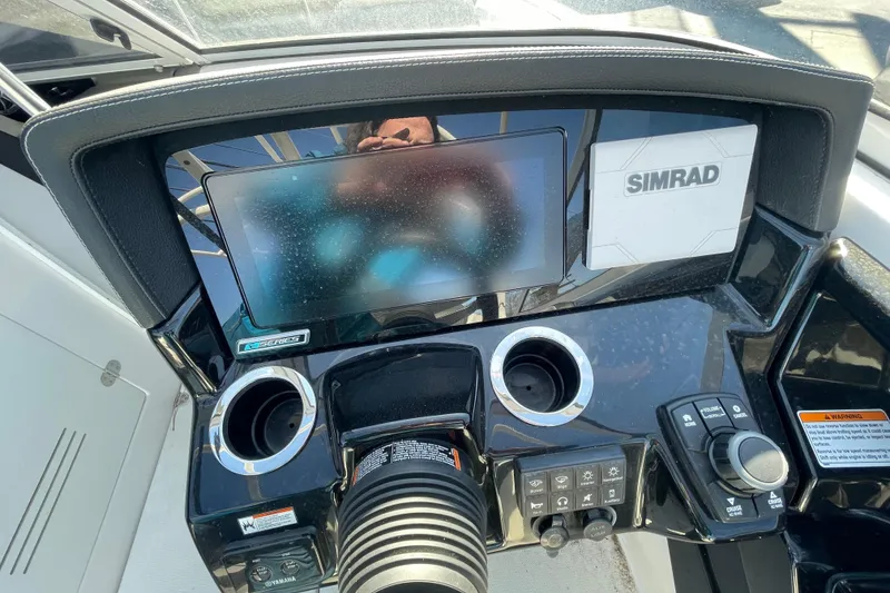 Slide: The Image of 2019 Yamaha Boats 242 Limited S E-Series dashboard with Simrad display and controls. - 6