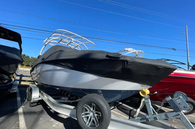 Slide: The Image of 2019 Yamaha Boats 242 Limited S E-Series covered on trailer, parked outdoors. - 8