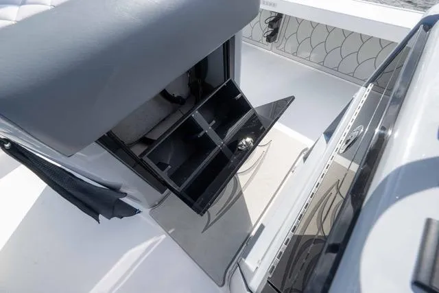 Slide: The Image of 2024 Islamorada Boatworks 24 interior storage compartment with open drawers and sleek design. - 11