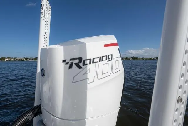 Slide: The Image of 2024 Islamorada Boatworks 24 with Racing 400 engine on a calm water backdrop. - 15