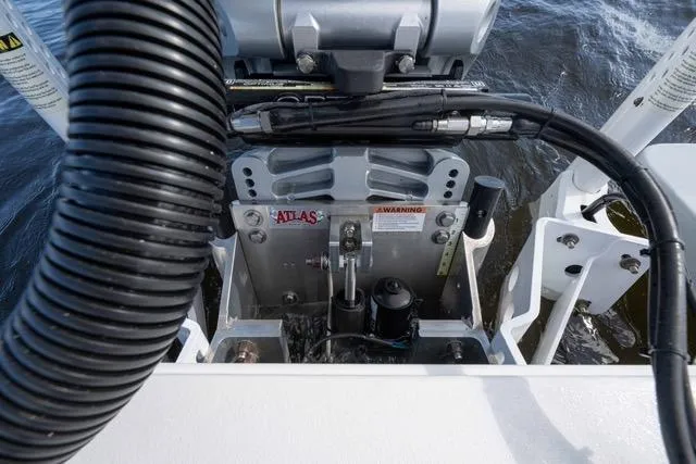 Slide: The Image of 2024 Islamorada Boatworks 24 engine mount with hydraulic components on water. - 16