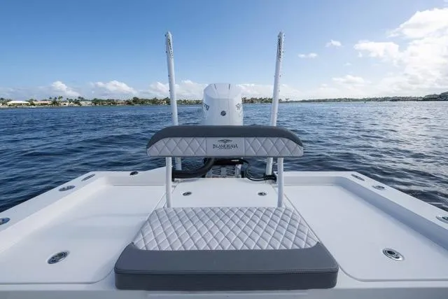 Slide: The Image of 2024 Islamorada Boatworks 24, featuring a sleek deck and comfortable seating on open water. - 18