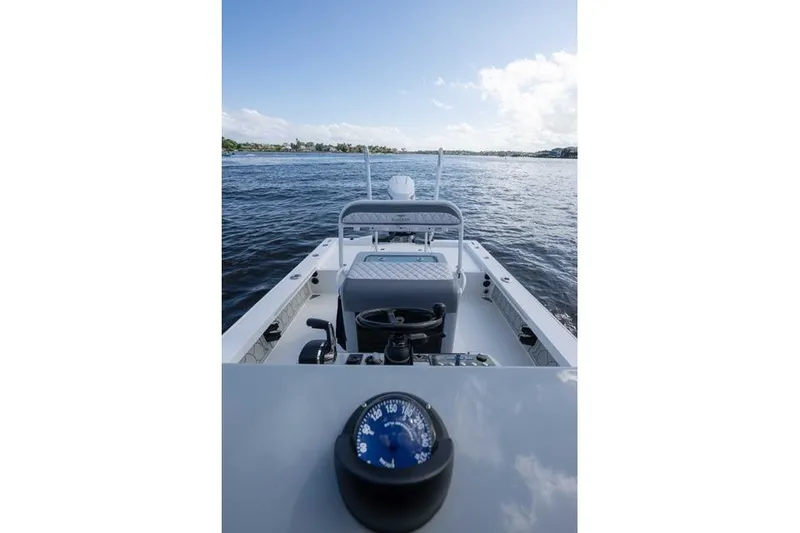 Slide: The Image of 2024 Islamorada Boatworks 24 on water, featuring a compass and open deck view. - 20