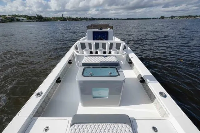 Slide: The Image of 2024 Islamorada Boatworks 24 on water, featuring spacious deck and modern design. - 23