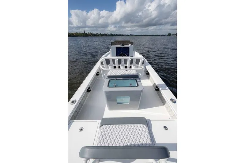 Slide: The Image of 2024 Islamorada Boatworks 24 on water, featuring sleek design and spacious deck. - 24